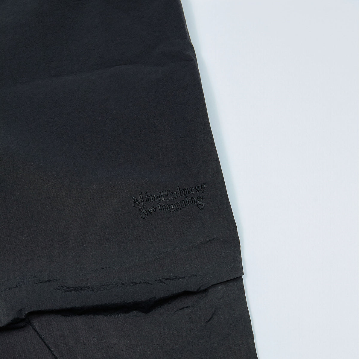 NYLON TRACK TROUSERS “MINDFULNESS SWIMMING” ー BLK