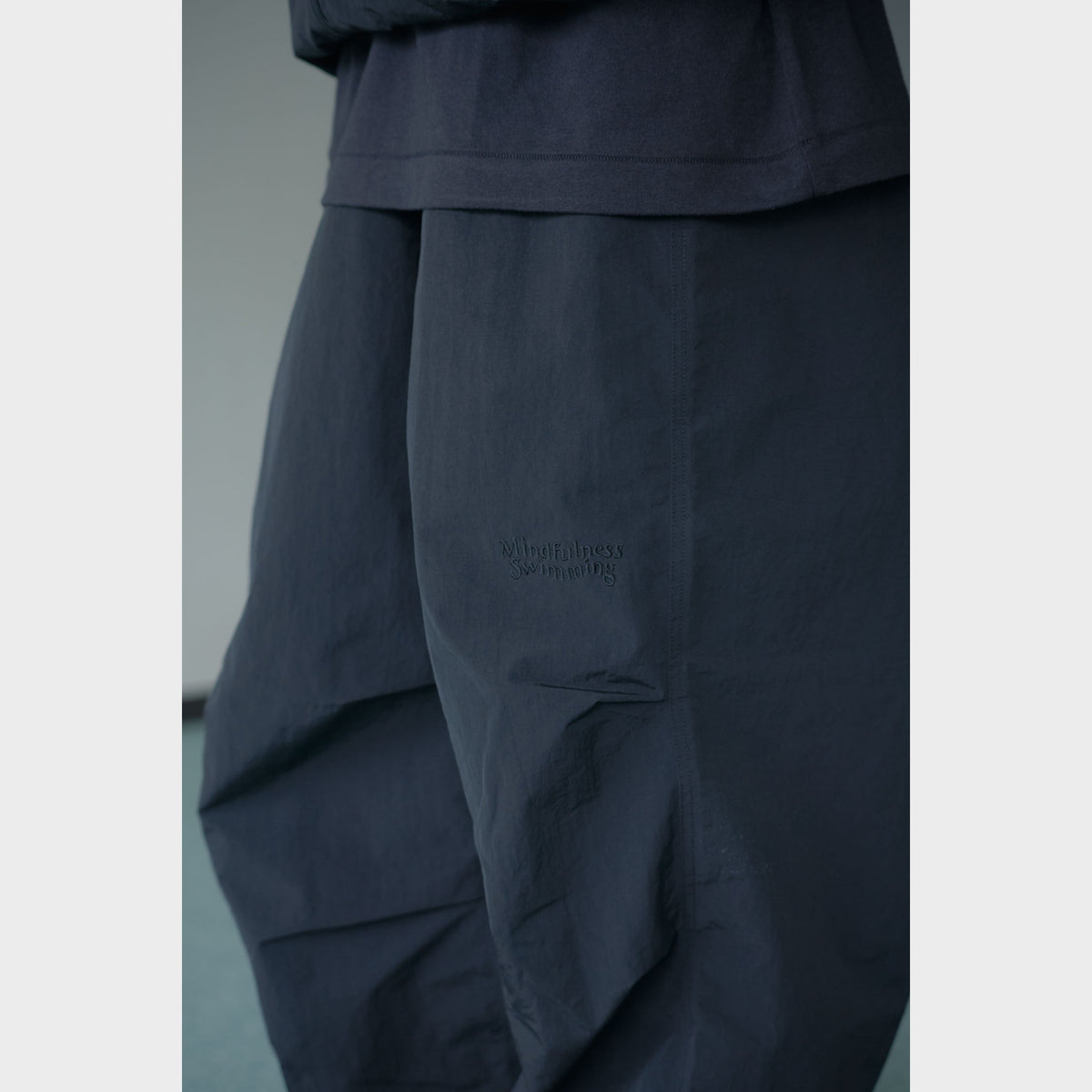 NYLON TRACK TROUSERS “MINDFULNESS SWIMMING” ー BLK